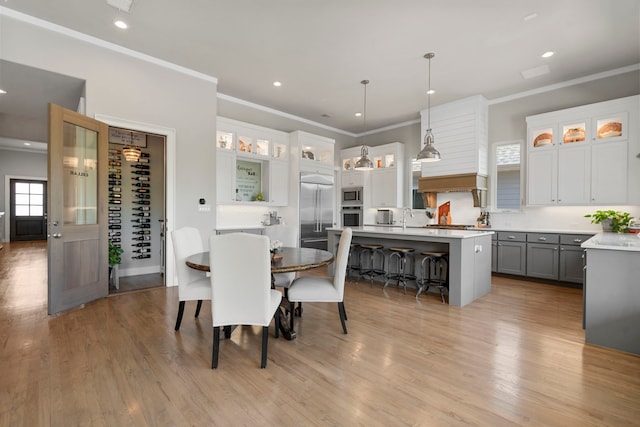 5000 Brush Hill Rd, Carrollton, TX 75010 - dining area featuring crown molding, light wood-style floors, and recessed lighting