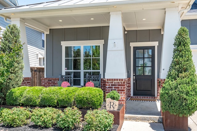 5000 Brush Hill Rd, Carrollton, TX 75010 - entrance to property featuring a porch, brick siding, a standing seam roof, board and batten siding, and metal roof