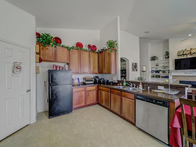 3929 Bonita Springs Dr, Fort Worth, TX 76123 - kitchen featuring freestanding refrigerator, dishwasher, a sink, arched walkways, and brown cabinets