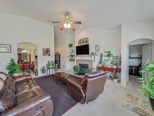 3929 Bonita Springs Dr, Fort Worth, TX 76123 - carpeted living room with arched walkways, a fireplace, a ceiling fan, and high vaulted ceiling