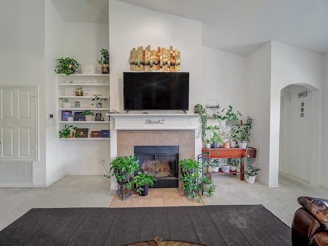 3929 Bonita Springs Dr, Fort Worth, TX 76123 - carpeted living area featuring arched walkways and a tile fireplace