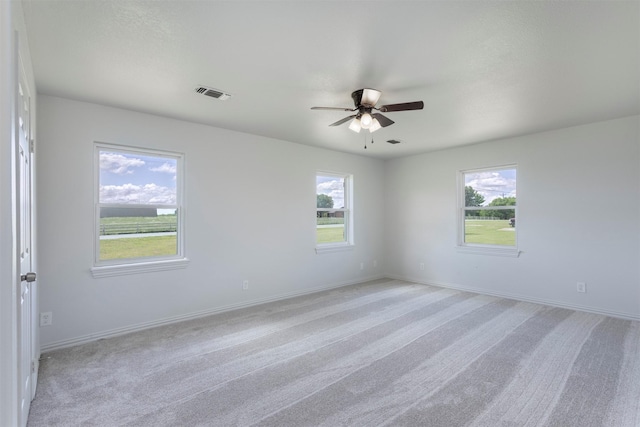 943 Lone Star Rd, Whitesboro, TX 76273 - empty room featuring a ceiling fan, plenty of natural light, light colored carpet, and baseboards