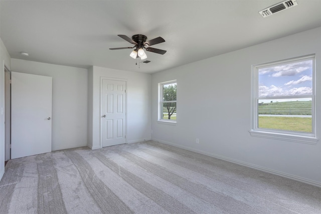943 Lone Star Rd, Whitesboro, TX 76273 - unfurnished bedroom with light colored carpet, ceiling fan, baseboards, and a closet