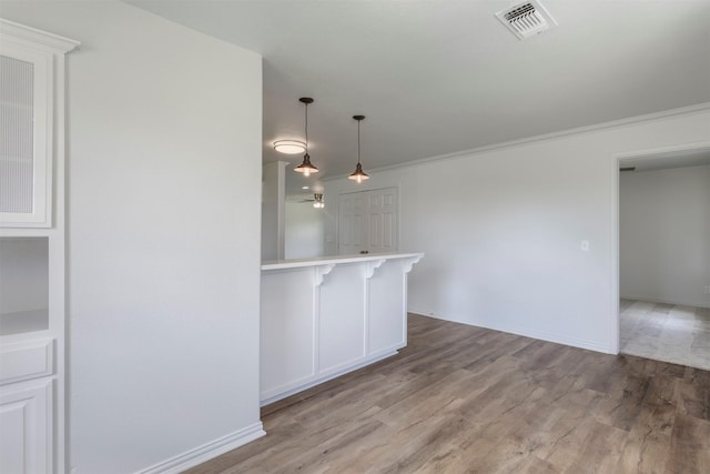 943 Lone Star Rd, Whitesboro, TX 76273 - unfurnished dining area with wood finished floors, crown molding, and baseboards