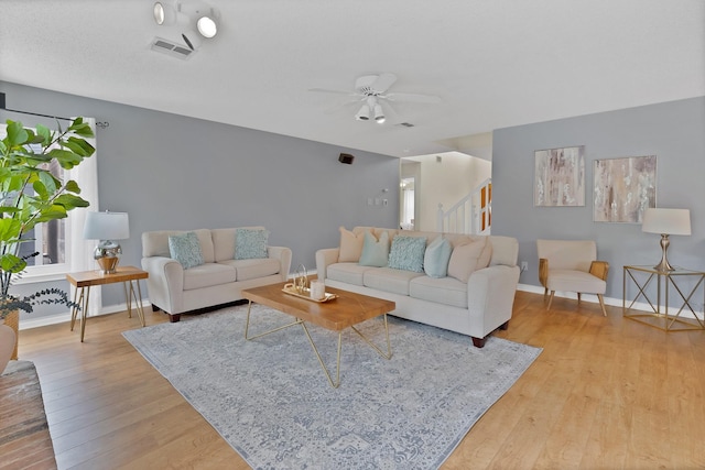 2200 Bantry Ln, Arlington, TX 76002 - living room with light wood-style floors, ceiling fan, baseboards, and stairway