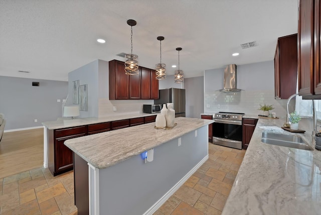 2200 Bantry Ln, Arlington, TX 76002 - kitchen with stainless steel appliances, wall chimney range hood, a center island, stone tile flooring, and recessed lighting