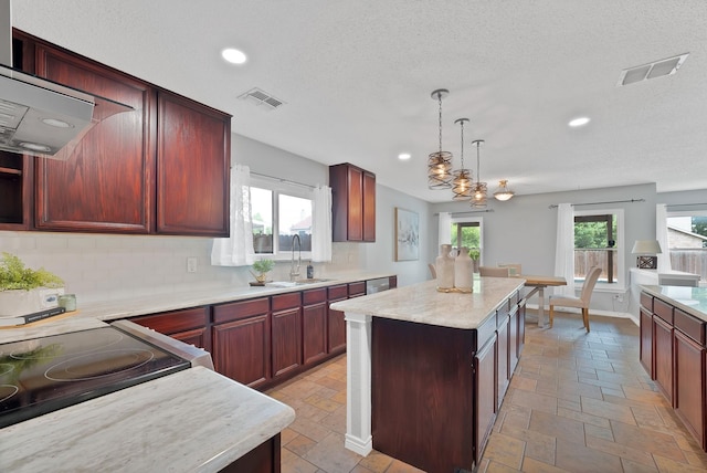 2200 Bantry Ln, Arlington, TX 76002 - kitchen with stone tile floors, a center island, backsplash, recessed lighting, and pendant lighting