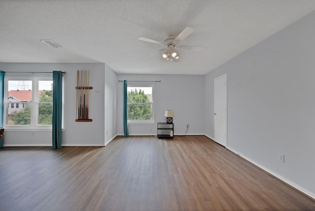 2200 Bantry Ln, Arlington, TX 76002 - empty room with wood finished floors, ceiling fan, a textured ceiling, and baseboards