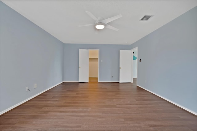 2200 Bantry Ln, Arlington, TX 76002 - unfurnished bedroom with wood finished floors, a walk in closet, baseboards, ceiling fan, and a closet