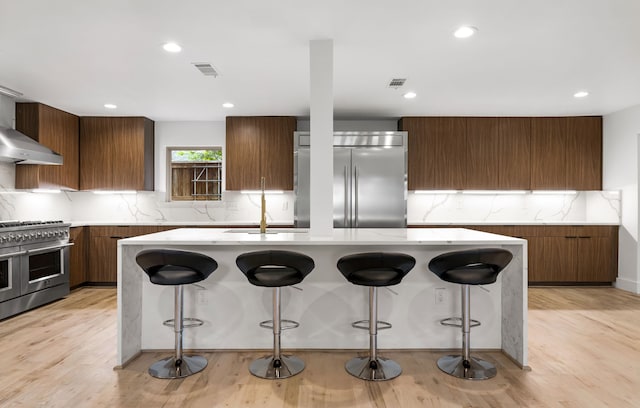 9415 Hill View Dr, Dallas, TX 75231 - kitchen featuring high quality appliances, modern cabinets, backsplash, a kitchen island with sink, and recessed lighting