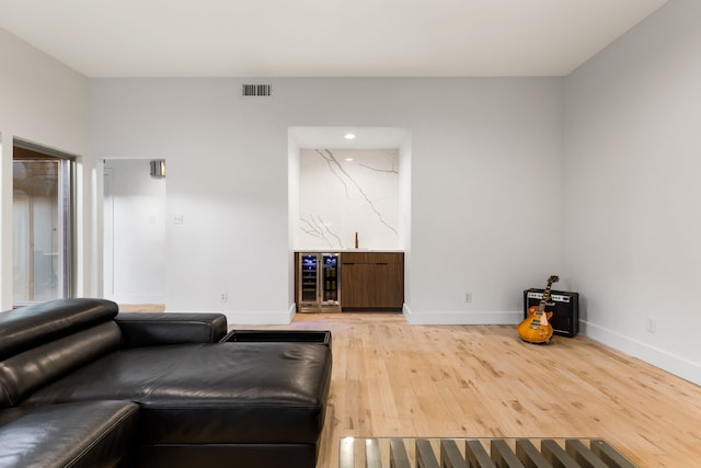 9415 Hill View Dr, Dallas, TX 75231 - living room featuring wine cooler, light wood-style flooring, baseboards, recessed lighting, and bar area