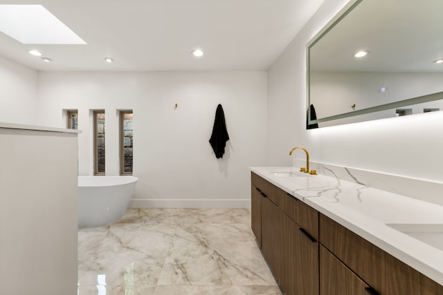 9415 Hill View Dr, Dallas, TX 75231 - bathroom with marble finish flooring, a skylight, double vanity, a soaking tub, and recessed lighting