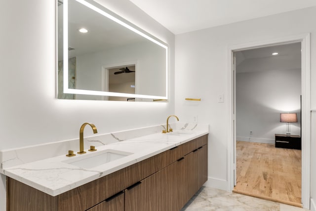 9415 Hill View Dr, Dallas, TX 75231 - bathroom with double vanity, baseboards, and marble look tile flooring