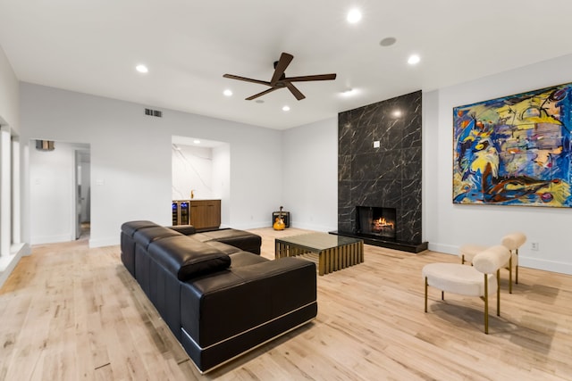 9415 Hill View Dr, Dallas, TX 75231 - living room with a ceiling fan, recessed lighting, light wood-type flooring, baseboards, and a high end fireplace