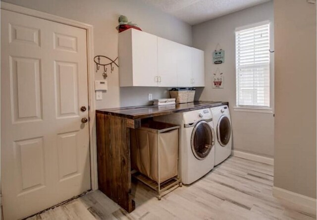2505 Wilma Ln, Plano, TX 75074 - washroom featuring washing machine and clothes dryer, cabinet space, and light wood-style flooring