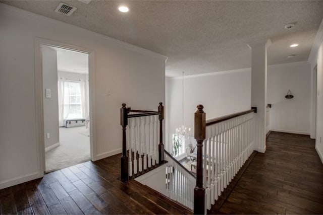 2505 Wilma Ln, Plano, TX 75074 - corridor with an upstairs landing, hardwood / wood-style flooring, ornamental molding, a textured ceiling, and recessed lighting