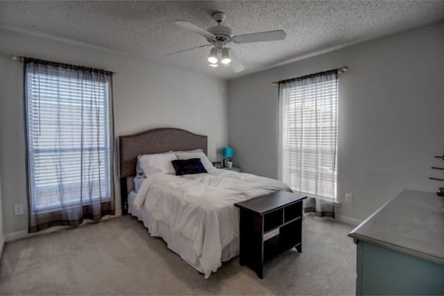2505 Wilma Ln, Plano, TX 75074 - bedroom with light colored carpet, multiple windows, a textured ceiling, and a ceiling fan