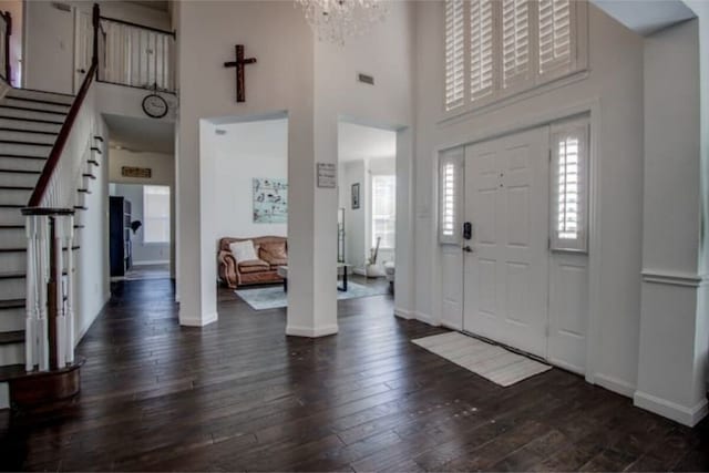 2505 Wilma Ln, Plano, TX 75074 - entrance foyer featuring stairway, a chandelier, a towering ceiling, and dark wood-style flooring