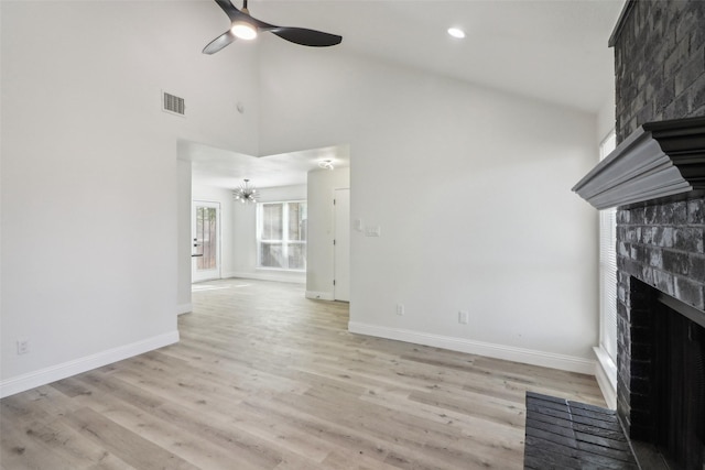 2401 Sherry St Unit A & B, Arlington, TX 76014 - unfurnished living room featuring a fireplace, a ceiling fan, a chandelier, baseboards, and light wood finished floors