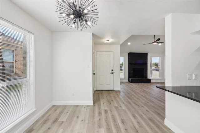 2401 Sherry St Unit A & B, Arlington, TX 76014 - unfurnished living room with a chandelier, light wood-style flooring, a fireplace, and baseboards