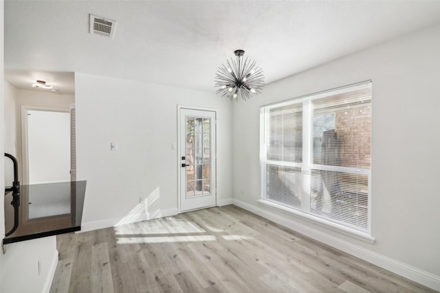 2401 Sherry St Unit A & B, Arlington, TX 76014 - unfurnished dining area with a chandelier, wood finished floors, and baseboards