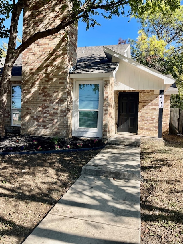 2401 Sherry St Unit A & B, Arlington, TX 76014 - view of side of home with brick siding, fence, a chimney, and roof with shingles