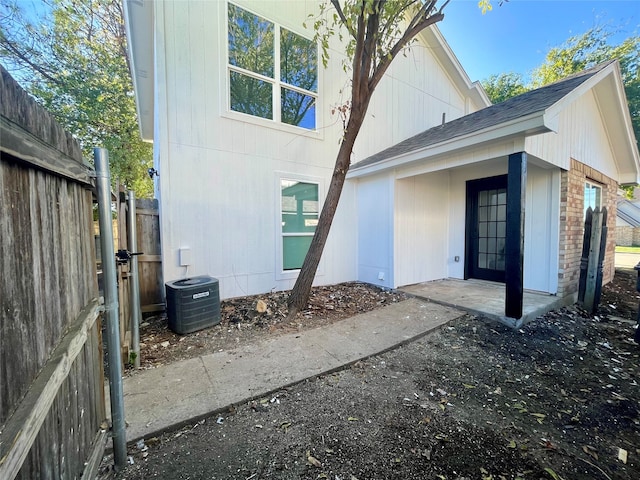 2401 Sherry St Unit A & B, Arlington, TX 76014 - rear view of house with central air condition unit, a shingled roof, fence, and a gate