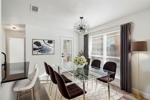 2401 Sherry St Unit A & B, Arlington, TX 76014 - dining area featuring a chandelier, wood finished floors, and baseboards
