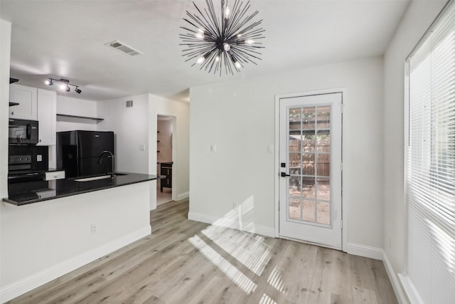 2401 Sherry St Unit A & B, Arlington, TX 76014 - kitchen with black appliances, dark countertops, a sink, a chandelier, and light wood-style floors