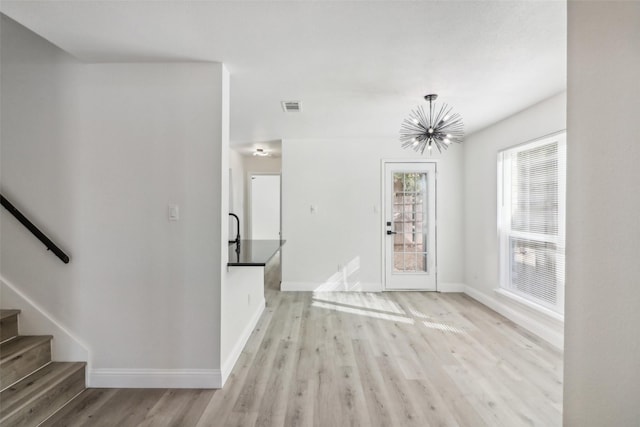 2401 Sherry St Unit A & B, Arlington, TX 76014 - unfurnished living room featuring a chandelier, baseboards, light wood finished floors, and stairs