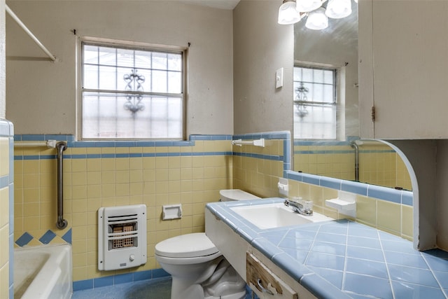 1231 Arizona Ave, Dallas, TX 75216 - full bath with heating unit, tile walls, healthy amount of natural light, toilet, and a bath