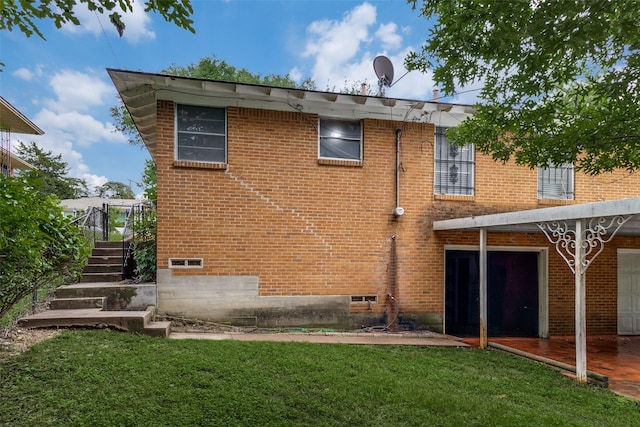 1231 Arizona Ave, Dallas, TX 75216 - rear view of house featuring brick siding, a lawn, and stairs
