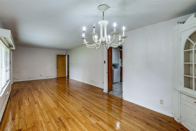 1231 Arizona Ave, Dallas, TX 75216 - empty room featuring light wood-type flooring, a chandelier, and baseboards