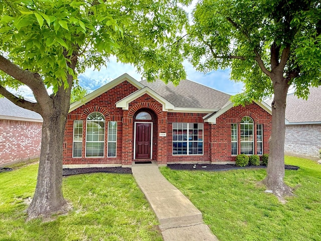 3104 Wind Flower Ln, Mckinney, TX 75070 - view of front facade featuring brick siding, a front lawn, and roof with shingles