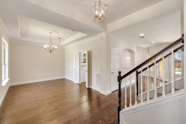 102 Fontana Ct, Allen, TX 75013 - entrance foyer featuring a chandelier, dark wood-style floors, baseboards, arched walkways, and a tray ceiling