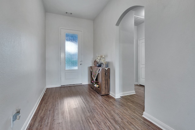5500 Persimmon Dr, Denton, TX 76207 - entrance foyer with arched walkways, wood finished floors, and baseboards