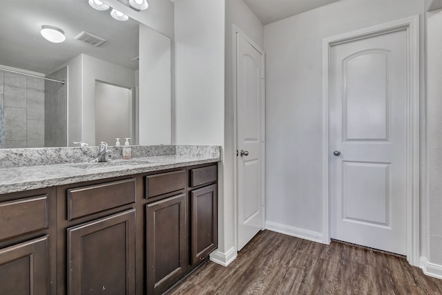 5500 Persimmon Dr, Denton, TX 76207 - bathroom with wood finished floors, vanity, baseboards, and a shower