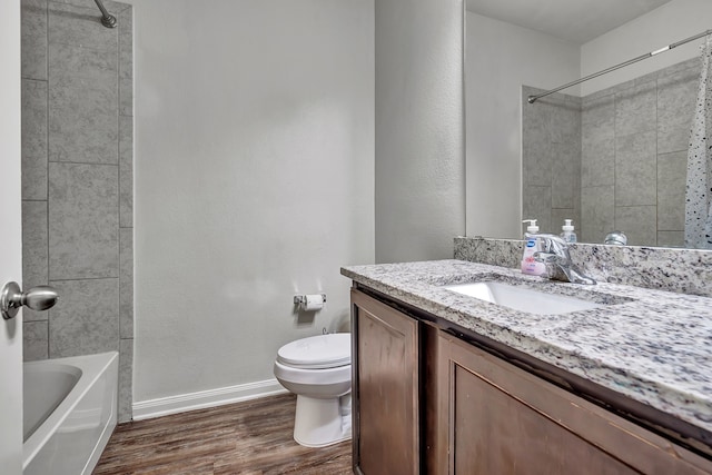 5500 Persimmon Dr, Denton, TX 76207 - bathroom with wood finished floors, toilet, baseboards, vanity, and tub / shower combination