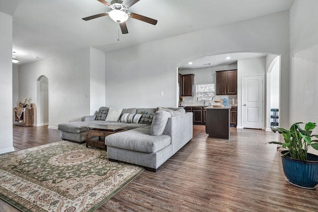 5500 Persimmon Dr, Denton, TX 76207 - living room featuring arched walkways, ceiling fan, dark wood finished floors, and baseboards