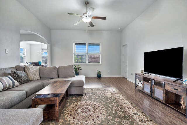 5500 Persimmon Dr, Denton, TX 76207 - living room with ceiling fan, arched walkways, wood finished floors, and baseboards