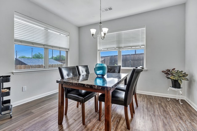 5500 Persimmon Dr, Denton, TX 76207 - dining space with a chandelier, healthy amount of natural light, wood finished floors, and baseboards