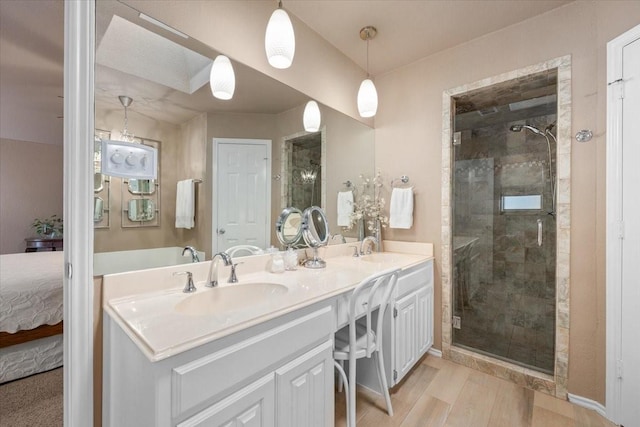 10013 Stoneleigh Dr, Benbrook, TX 76126 - ensuite bathroom with a stall shower, wood finished floors, and double vanity