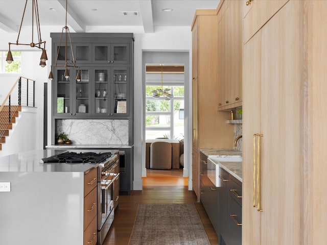 kitchen featuring stainless steel stove, dark wood-style flooring, decorative backsplash, glass insert cabinets, and beamed ceiling