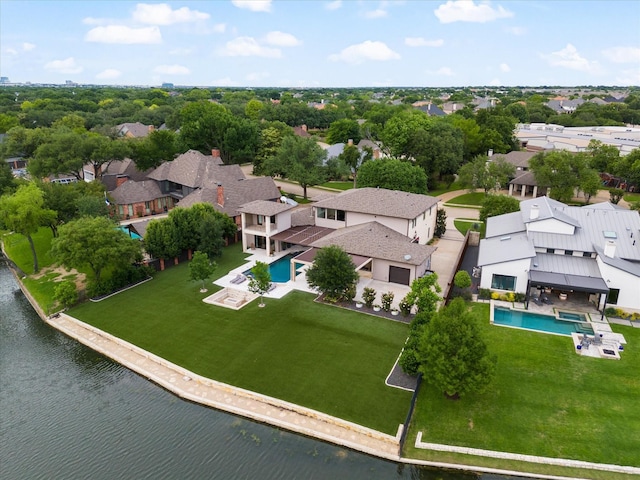 aerial view of residential area with a pool area and a nearby body of water