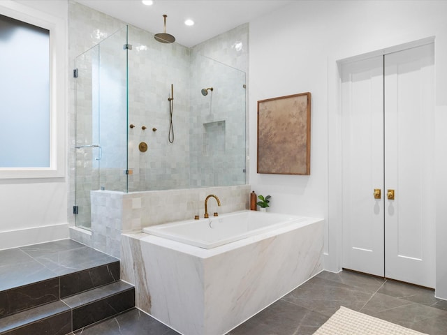 full bathroom with a stall shower, a garden tub, and recessed lighting