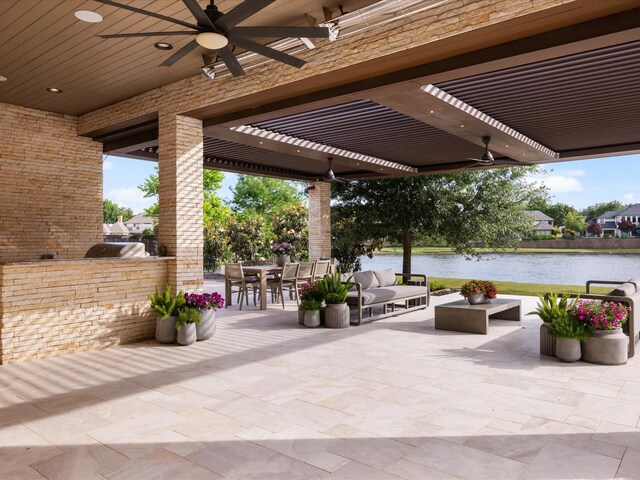 view of patio / terrace featuring a water view, outdoor dining space, area for grilling, a ceiling fan, and a pergola
