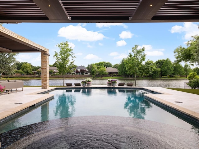 outdoor pool featuring a patio and a water view