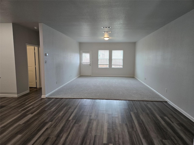 6310 Tropicana Ln, Forney, TX 75126 - spare room featuring dark wood-style floors, baseboards, and a textured ceiling