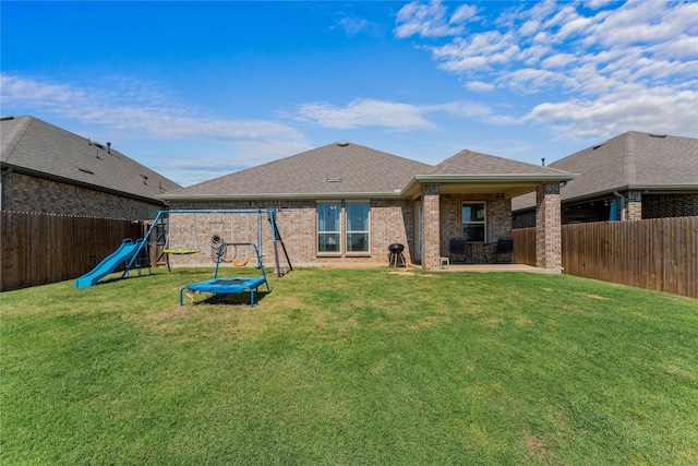 3008 Aransas Ave, Aubrey, TX 76227 - back of property with a playground, a patio, brick siding, and a shingled roof