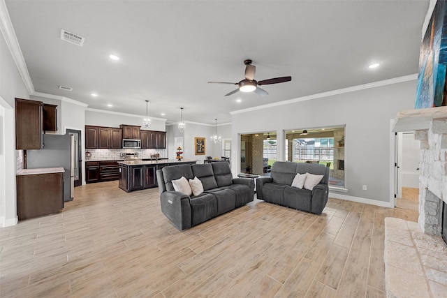 living area featuring ceiling fan, a stone fireplace, light wood-style flooring, recessed lighting, and baseboards